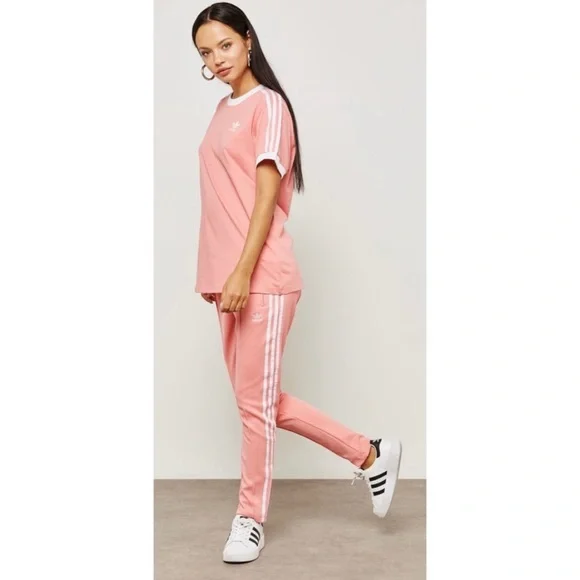 Adidas UO Women s Originals Superstar Trefoil Striped Peach Track Pants Size L Pants Jumpsuits